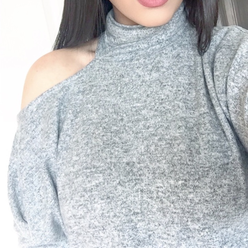 Grey turtleneck sweater with shoulder cut out